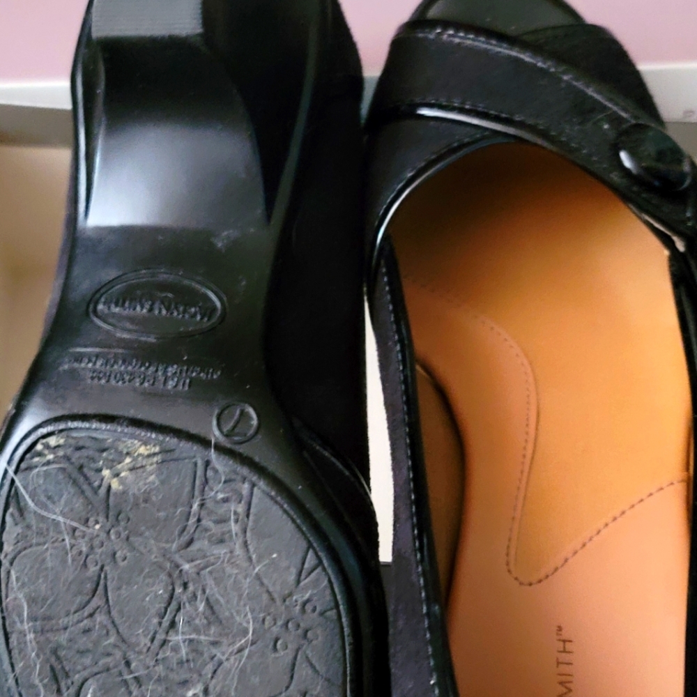 Black Jaclyn Smith flats with button detail.